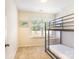 Cozy bedroom with carpet floors and a window with natural light; the room features a metal bunk bed at 13529 Browhill Ln, Charlotte, NC 28278