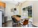 The dining room features a rustic wooden table with modern lighting and sliding doors to the exterior at 13529 Browhill Ln, Charlotte, NC 28278