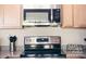 Close up of the kitchen with granite countertops, stainless steel appliances, and light wood cabinets at 13529 Browhill Ln, Charlotte, NC 28278