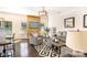 Bright living room featuring hardwood floors, stylish furniture, a modern light fixture, and a beautiful accent wall at 13529 Browhill Ln, Charlotte, NC 28278