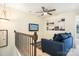 Cozy loft area featuring a comfortable blue sofa and modern decor at 13529 Browhill Ln, Charlotte, NC 28278