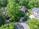 Aerial view of a beautiful home surrounded by lush greenery, mature trees and landscaping in a desirable neighborhood at 13822 Tributary Ct, Davidson, NC 28036