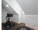 The attic features a window, hardwood floors, and exercise equipment at 13822 Tributary Ct, Davidson, NC 28036
