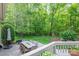 Inviting patio with an outdoor dining set, grill and landscaped yard, perfect for entertaining or relaxing outdoors at 13822 Tributary Ct, Davidson, NC 28036