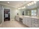Spacious bathroom featuring dual vanities, elegant lighting, and a walk-in closet at 13822 Tributary Ct, Davidson, NC 28036