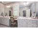 Bright bathroom with double vanity, white cabinets, large mirrors and natural light at 13822 Tributary Ct, Davidson, NC 28036