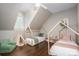 Playful bedroom with two stylish beds, cozy teepee, and an accent chair at 13822 Tributary Ct, Davidson, NC 28036