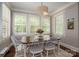 Cozy dining room area with ample natural light from shuttered windows and decorative light fixture at 13822 Tributary Ct, Davidson, NC 28036