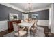 Elegant dining room featuring wainscoting, a rustic chandelier, and a beautiful table for gatherings at 13822 Tributary Ct, Davidson, NC 28036