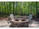 A cozy brick fire pit with chairs, perfect for outdoor entertaining and relaxation at 13822 Tributary Ct, Davidson, NC 28036