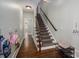 Inviting hallway featuring hardwood floors, staircase with carpet runner and decorative details at 13822 Tributary Ct, Davidson, NC 28036