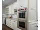 Gourmet kitchen featuring white cabinetry, stainless steel Wolf appliances, and granite countertops at 13822 Tributary Ct, Davidson, NC 28036