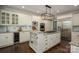 Spacious kitchen with stainless steel appliances, granite countertops, island cooktop, and modern lighting at 13822 Tributary Ct, Davidson, NC 28036