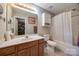 Neutral bathroom featuring a vanity, toilet, and shower-tub combination with a curtain at 140 Reid Ln, Pineville, NC 28134