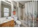 Bright bathroom with a shower-tub combo, vanity, and linen storage at 140 Reid Ln, Pineville, NC 28134
