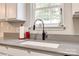 Modern kitchen sink beneath a bright window, complemented by gray countertops at 140 Reid Ln, Pineville, NC 28134
