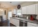 Bright kitchen with modern appliances, white cabinets, and dark countertops for a clean and functional design at 140 Reid Ln, Pineville, NC 28134
