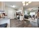 Modern kitchen featuring stainless steel appliances, dark wood floors, and an open layout to the living room at 140 Reid Ln, Pineville, NC 28134
