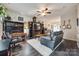 Cozy living room featuring dark wood floors, a ceiling fan, and a comfortable layout for relaxation at 140 Reid Ln, Pineville, NC 28134