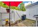 Private patio area featuring white fencing, and a storage shed, creating a cozy outdoor space at 140 Reid Ln, Pineville, NC 28134
