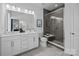 Modern bathroom featuring double sinks, sleek vanities, a shower with glass door, and tile flooring at 14012 Felix Ln # 7, Charlotte, NC 28277