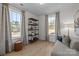 Sunlit bedroom with wood-look flooring, decorative shelving, and a comfortable chaise lounge at 14012 Felix Ln # 7, Charlotte, NC 28277