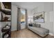 Bright bedroom features wood-look flooring, decor shelving, a comfortable chaise lounge, and natural light at 14012 Felix Ln # 7, Charlotte, NC 28277