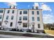 Exterior shot of a modern townhome community with white siding, dark trim, and well-manicured landscaping at 14012 Felix Ln # 7, Charlotte, NC 28277