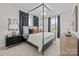 Spacious main bedroom features a four-poster bed and windows providing natural light at 14012 Felix Ln # 7, Charlotte, NC 28277