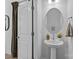Elegant powder room with pedestal sink, decorative mirror, and neutral color scheme at 14012 Felix Ln # 7, Charlotte, NC 28277