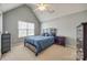 Bright bedroom featuring a vaulted ceiling, ceiling fan, and window providing natural light at 1404 Peachcroft Rd, Charlotte, NC 28216