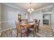 Elegant dining room showcases modern wood flooring and an open layout to the living room at 1404 Peachcroft Rd, Charlotte, NC 28216