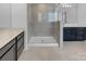 Stylish bathroom with a glass enclosed shower, dual vanities, and modern finishes at 14106 Ridgewater Way, Charlotte, NC 28278