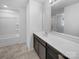 Clean bathroom featuring a shower-tub combo, vanity with a mirror and neutral tiling at 14106 Ridgewater Way, Charlotte, NC 28278