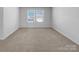 Bright bedroom features neutral carpet, white walls, and natural light from two windows at 14106 Ridgewater Way, Charlotte, NC 28278