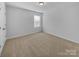 Bright bedroom features neutral carpet, white walls, and natural light from a window at 14106 Ridgewater Way, Charlotte, NC 28278