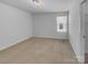 Bright bedroom features neutral carpet, white walls, and natural light from a window at 14106 Ridgewater Way, Charlotte, NC 28278