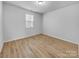Bright, empty bedroom with hardwood floors, window, and neutral paint, ready for personalization at 14106 Ridgewater Way, Charlotte, NC 28278