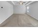 Spacious bedroom features neutral carpet, white walls, tray ceiling, and a ceiling fan at 14106 Ridgewater Way, Charlotte, NC 28278