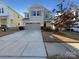 Charming two-story home featuring a two-car garage, a well-manicured lawn, and inviting curb appeal at 14106 Ridgewater Way, Charlotte, NC 28278