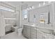 Modern bathroom features double vanity, large mirror and tiled shower with glass door at 15328 Ballancroft Pkwy # 18, Charlotte, NC 28277