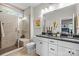Modern bathroom with glass shower, double sink vanity, and neutral color scheme, offering style and comfort at 15340 Ballancroft Pkwy # 15, Charlotte, NC 28277