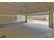 Spacious unfinished garage with concrete floor, exposed ceiling, and an open garage door at 15340 Ballancroft Pkwy # 15, Charlotte, NC 28277