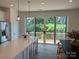 Bright kitchen featuring an island, stainless steel appliances, and sliding glass doors to the deck at 15340 Ballancroft Pkwy # 15, Charlotte, NC 28277
