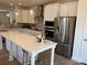 Bright, spacious kitchen with stainless steel appliances and a large island at 15340 Ballancroft Pkwy # 15, Charlotte, NC 28277