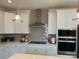 Well-equipped kitchen with stainless steel appliances, white cabinets and stylish backsplash at 15340 Ballancroft Pkwy # 15, Charlotte, NC 28277