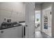Convenient laundry room with a washer, dryer, wire shelving, and access to another bedroom at 15340 Ballancroft Pkwy # 15, Charlotte, NC 28277