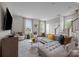 Cozy living room features a plush gray sofa, neutral decor, and large windows for natural light at 15340 Ballancroft Pkwy # 15, Charlotte, NC 28277