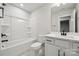 Modern bathroom featuring sleek vanity, tub with shower, and contemporary finishes at 2006 Mantle Ridge Dr, Indian Trail, NC 28079