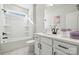 Bright bathroom featuring white vanity with black hardware, marble floors, and a tub with shower at 2006 Mantle Ridge Dr, Indian Trail, NC 28079